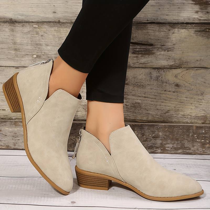 Women's casual slip-on boots with low block heel, sleek silhouette, and side openings for easy wear