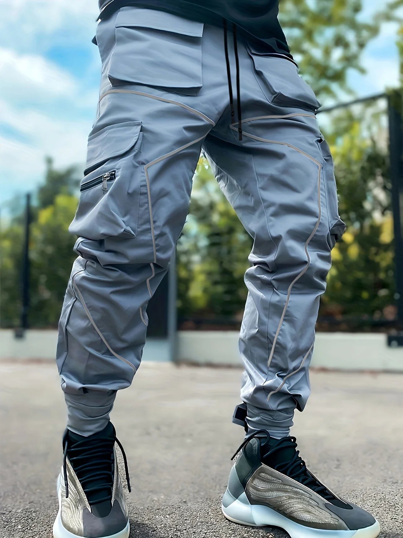 Black tapered cargo jogger with reflective high-visibility piping and featherweight performance fabric