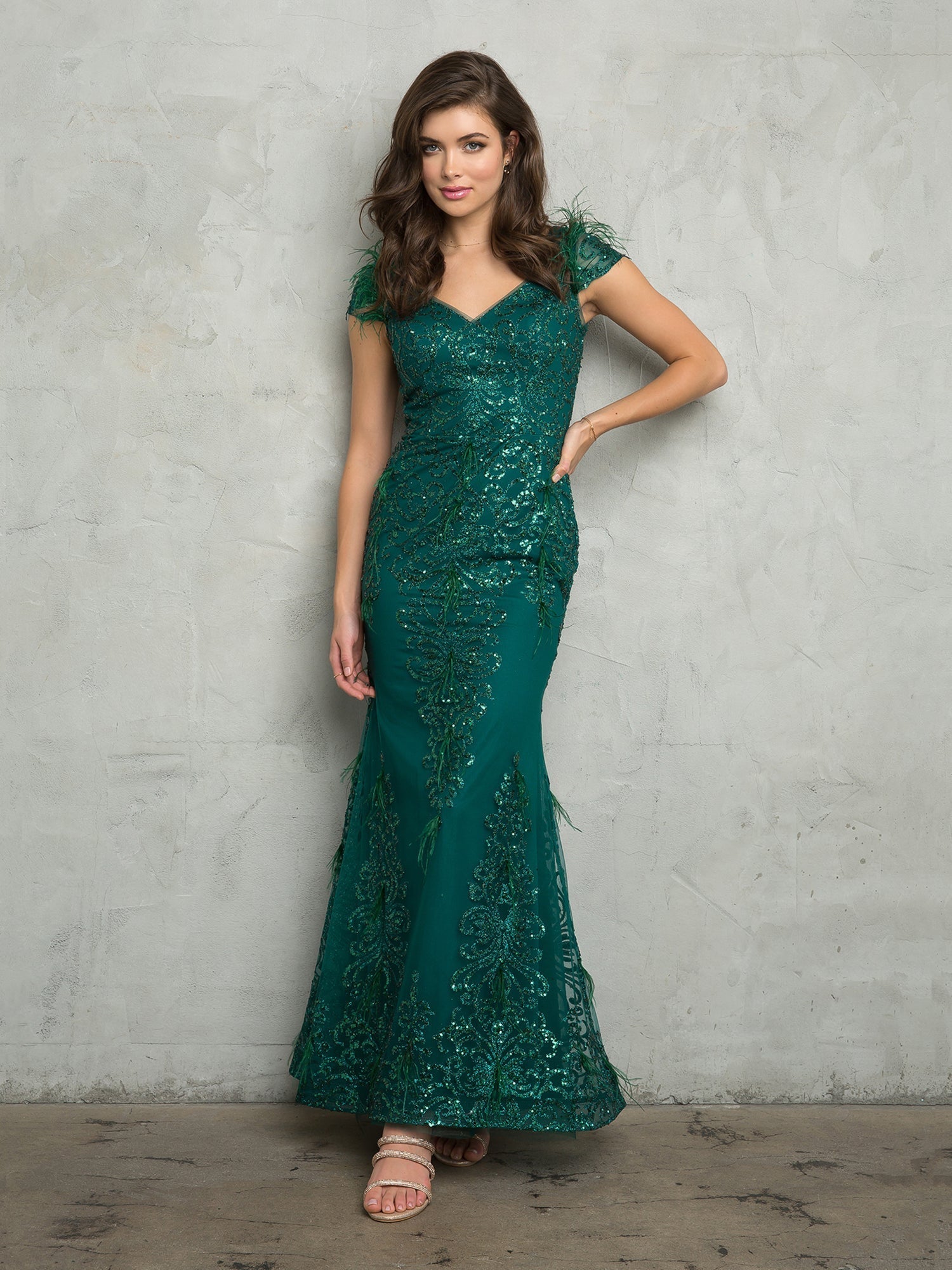 Women's fitted long glitter evening dress with cap sleeves, fit-and-flare silhouette, and feather accents
