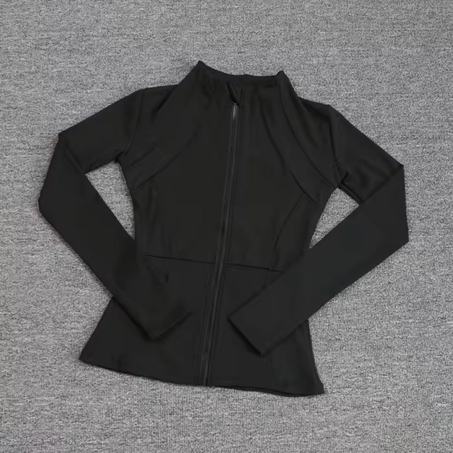 Women's fitted zip sports jacket in solid color with sleek silhouette for active training and everyday wear