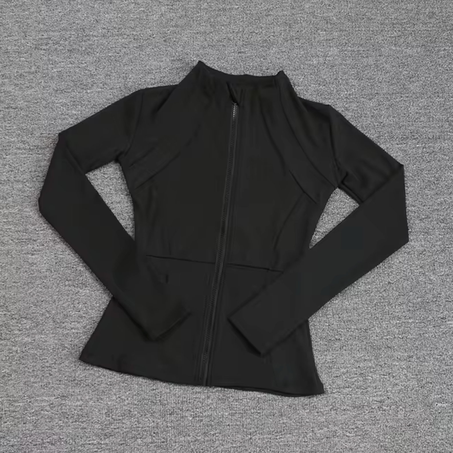 Women's fitted zip sports jacket in solid color with sleek silhouette for active training and everyday wear