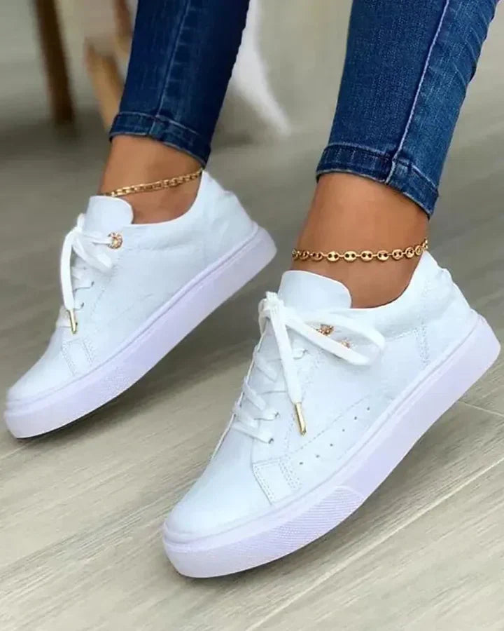 Gold accented sneakers for fashion-forward adults, modern versatile style with metallic details