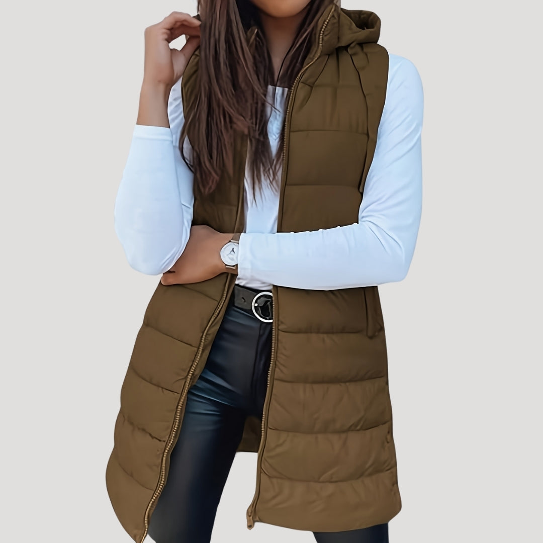 Women's lightweight hooded puffer vest in neutral tone, sleeveless quilted insulation for winter layering