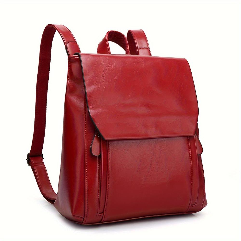 Women's black vegan leather structured backpack with flap closure and adjustable straps, sleek all-season design