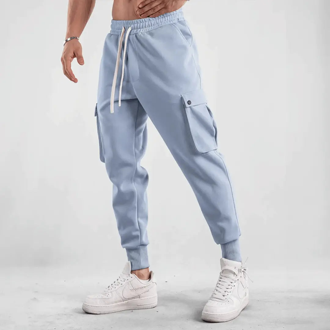 Black cargo joggers with adaptive flex fabric, tapered street-fit cut, and multi-pocket utility design