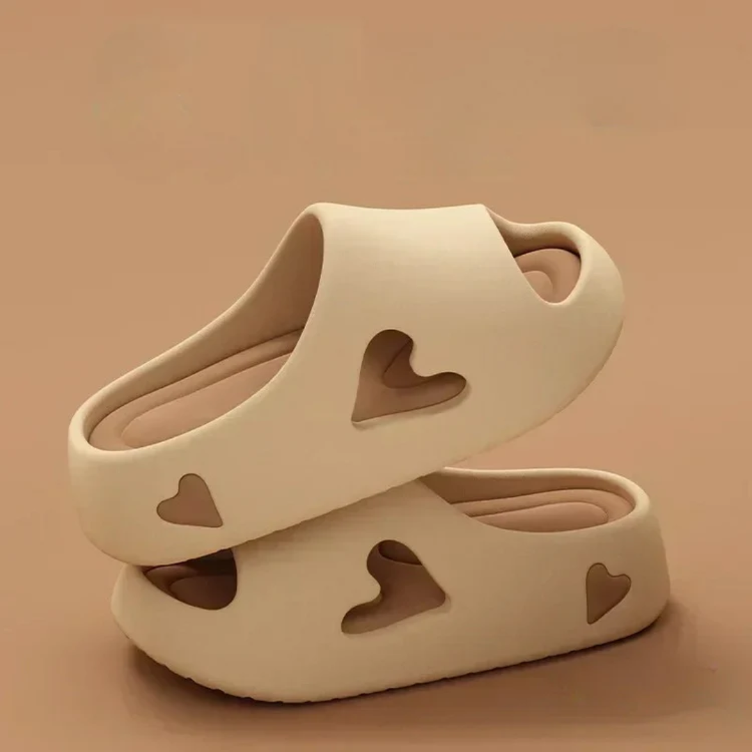 Women's ultra-light EVA foam slides with playful heart cutout details for all-day casual comfort