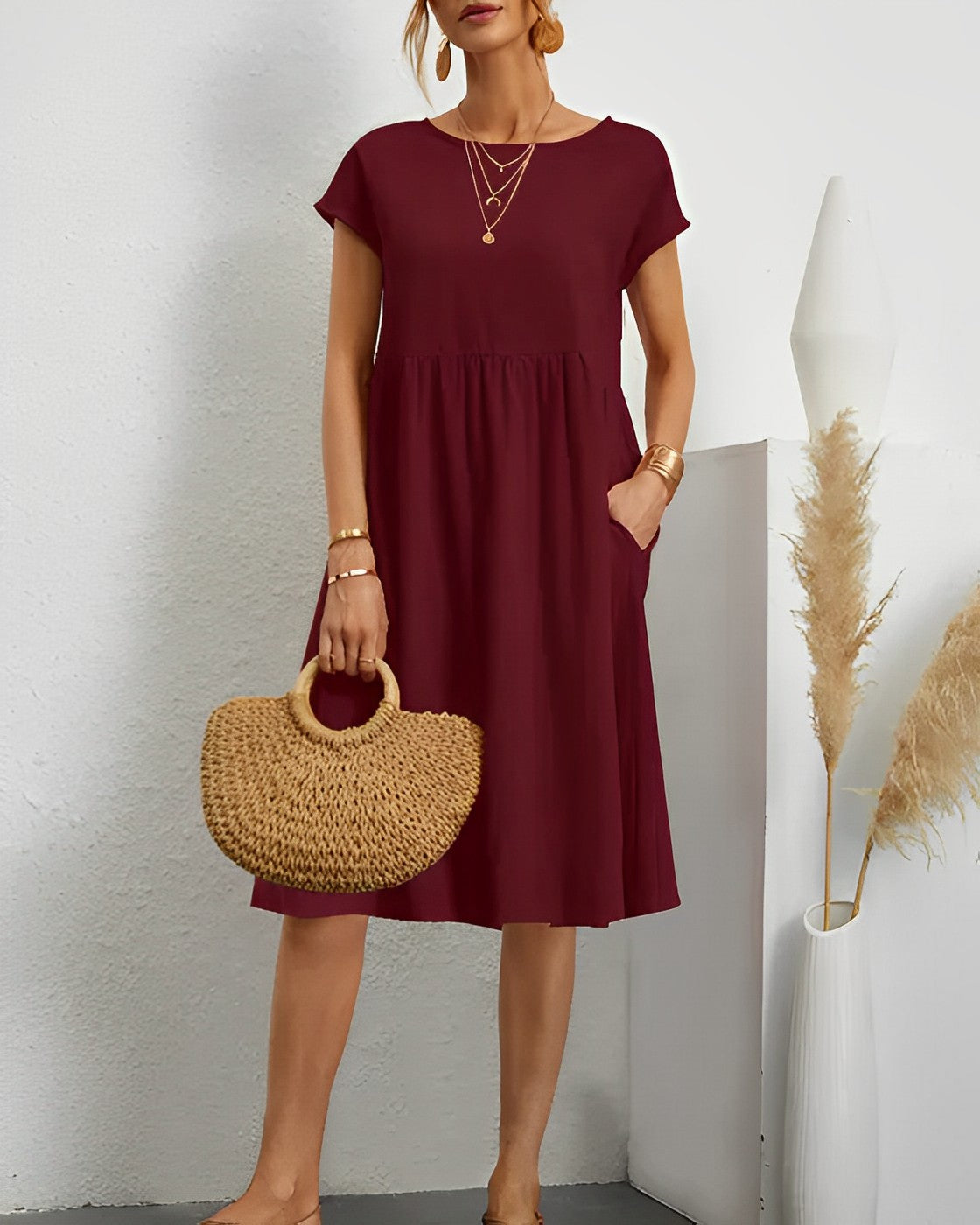 Women's loose-fit midi dress with short sleeves, round neck, and side pockets for effortless everyday style
