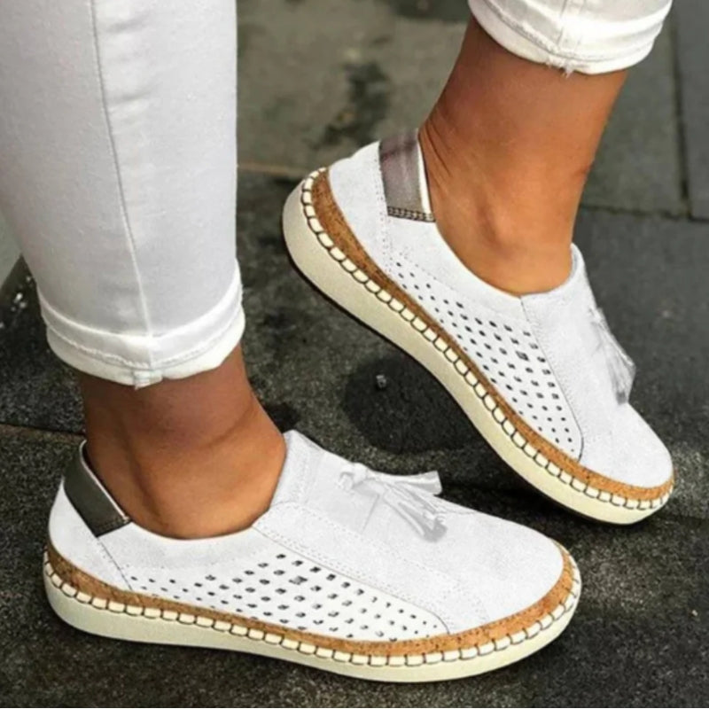 Women's white perforated slip-on sneakers with flexible sole and breathable upper for easy everyday wear