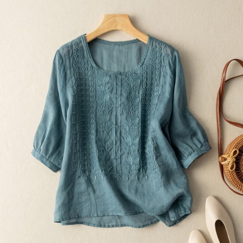 White linen blouse with stitched floral texture and curved high-low dipped hem for women
