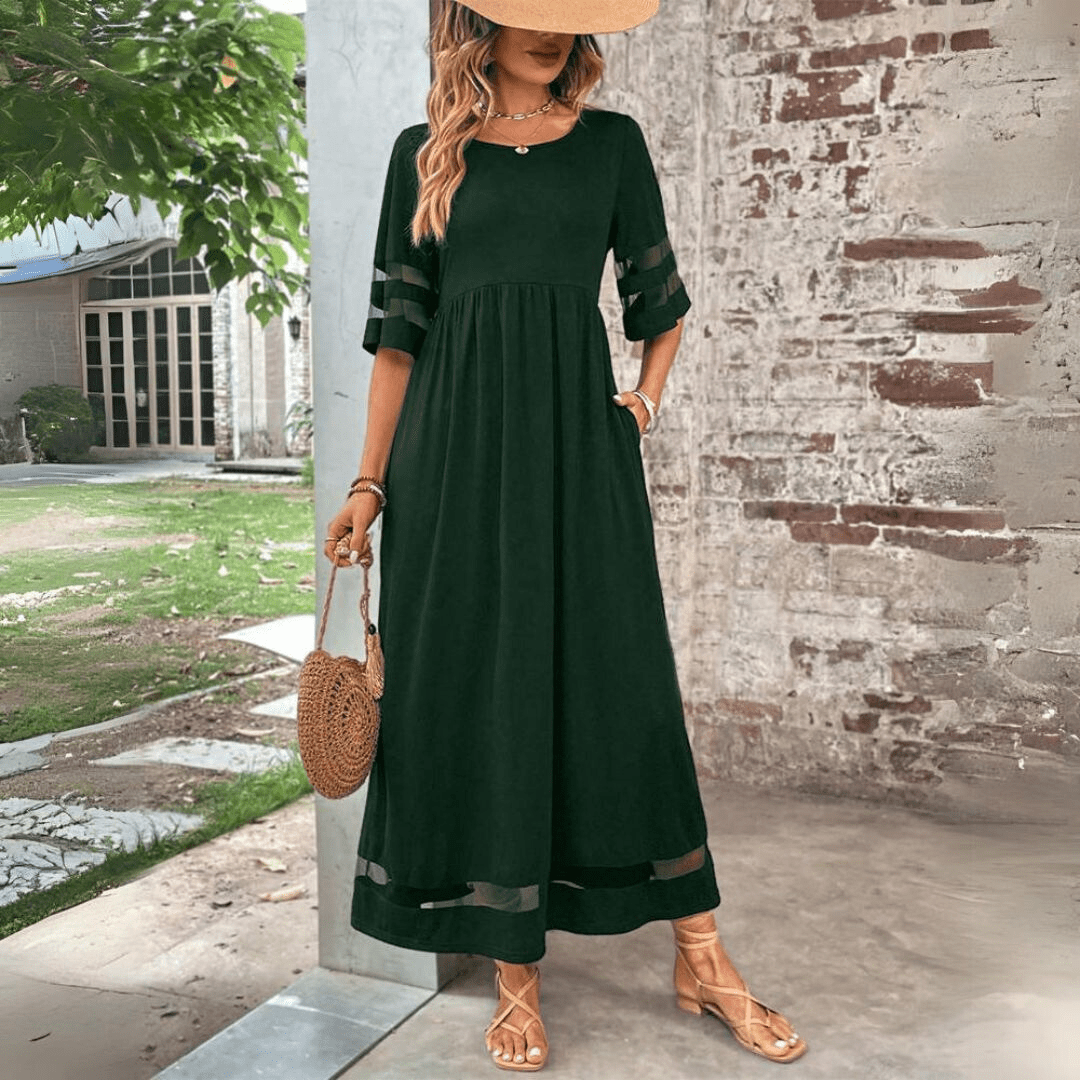 Black maxi dress with sheer sleeve panels, relaxed silhouette, raised waistline, round neckline