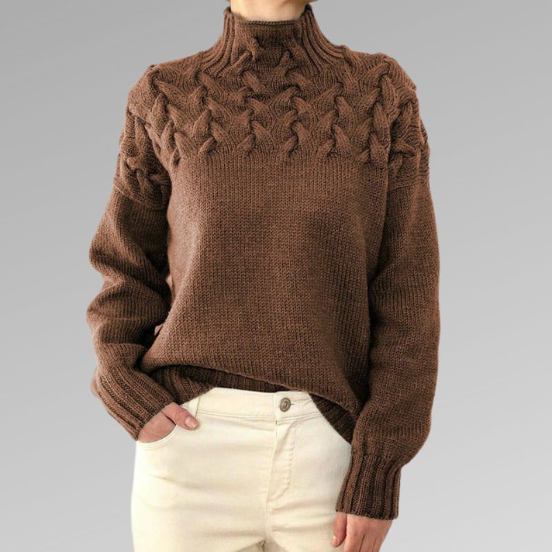 Women's cream cable knit high-neck sweater with raised cable pattern across upper bodice