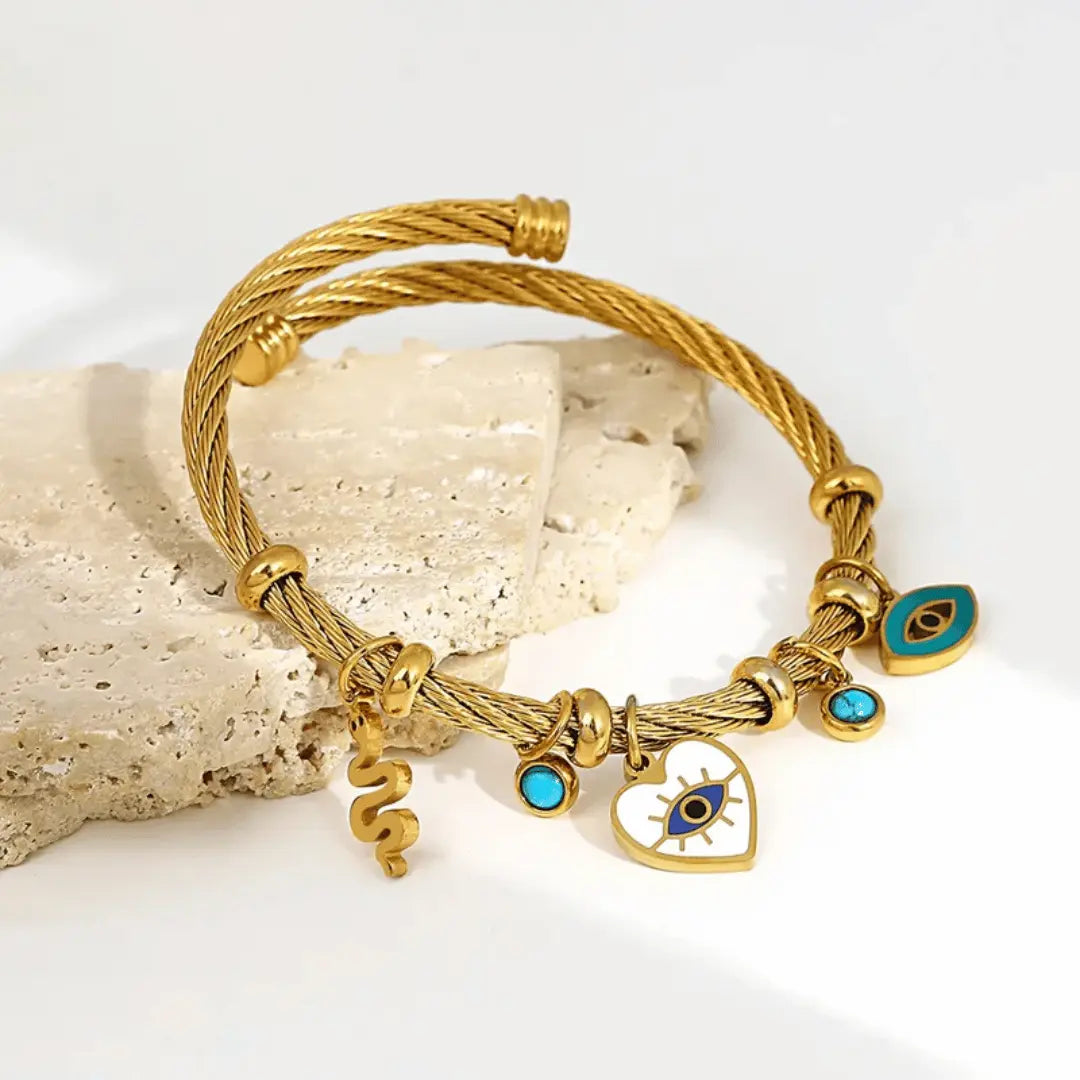 Handcrafted silver cuff bracelet with evil eye heart and snake charms for spiritual women