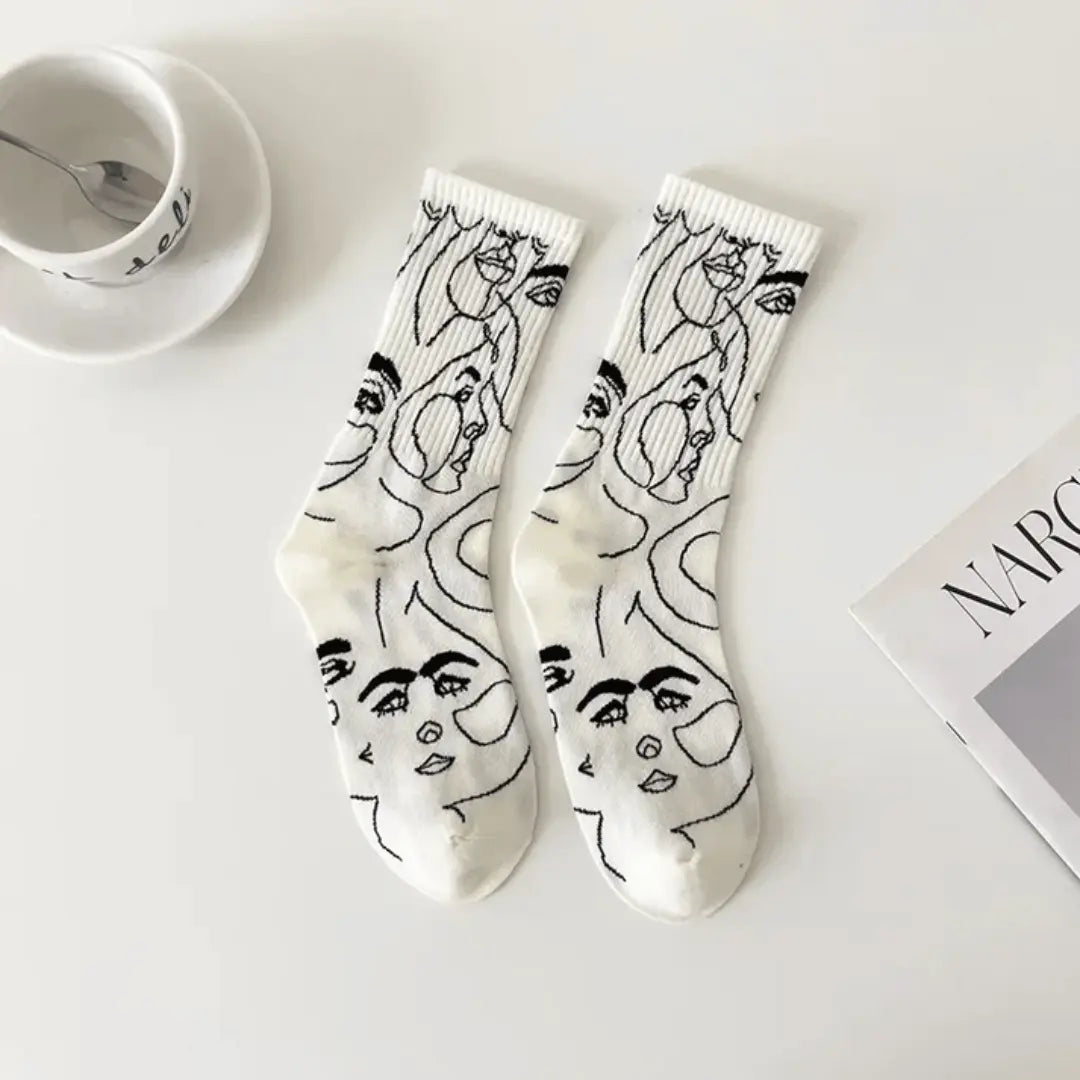 White cotton blend crew socks with bold abstract face line art design, unique wearable art gift
