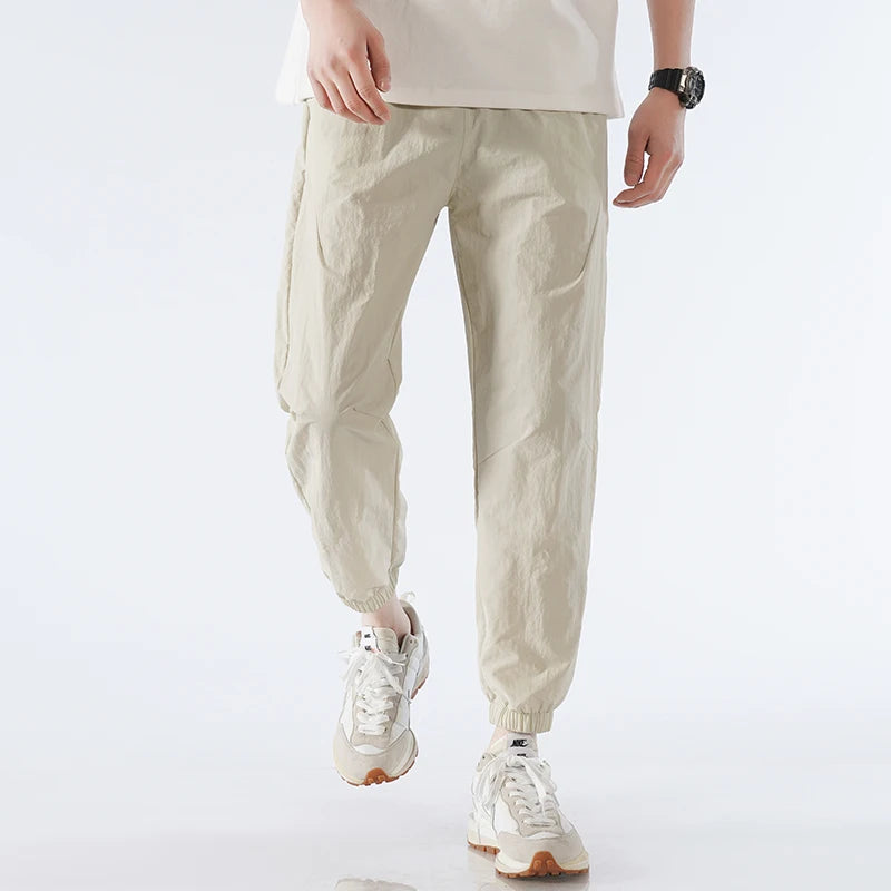 Men's black tapered nylon jogger pants lightweight quick-dry activewear sleek modern fit