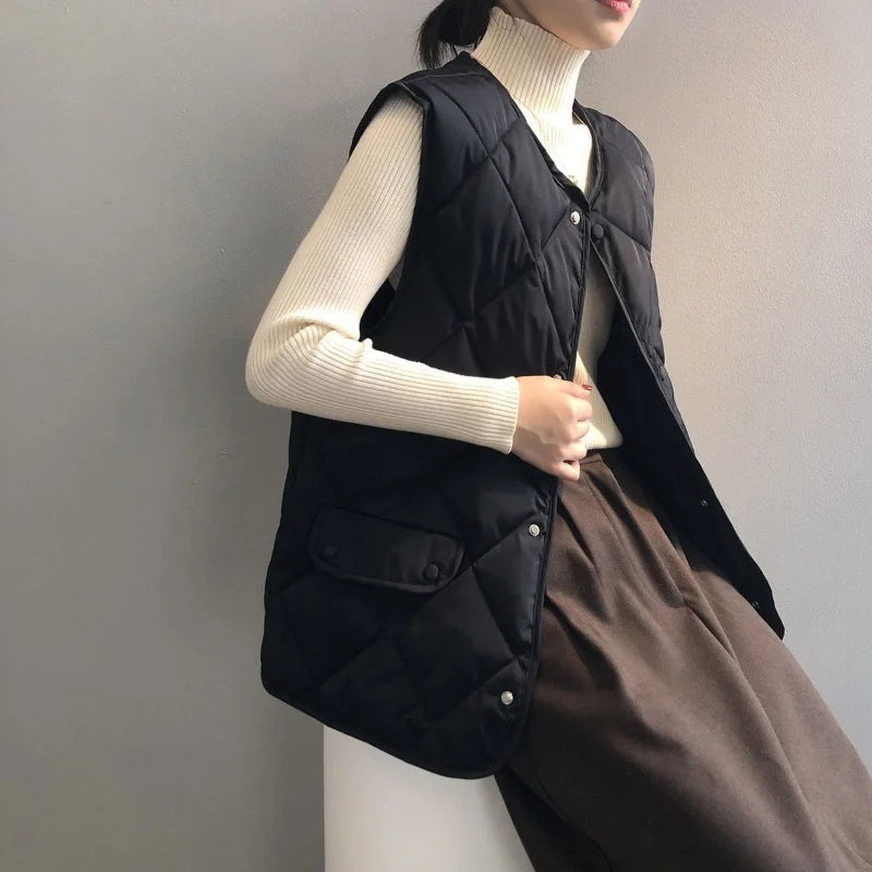 Women's black quilted bomber vest collarless diamond-stitched lightweight layering piece hidden snap closure