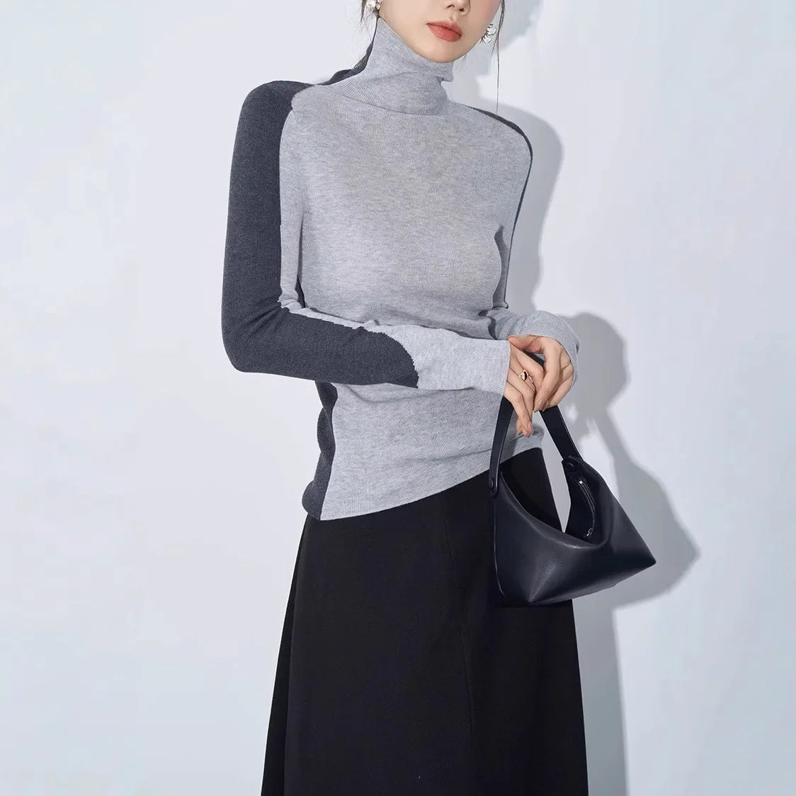 Women's mock neck contrast sleeve top with asymmetric long sleeves and sculpting fit in two-tone design