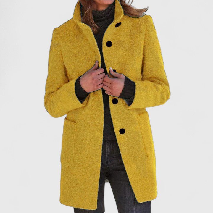 Women's mid-length structured coat in neutral tone, tailored silhouette with polished elongating cut