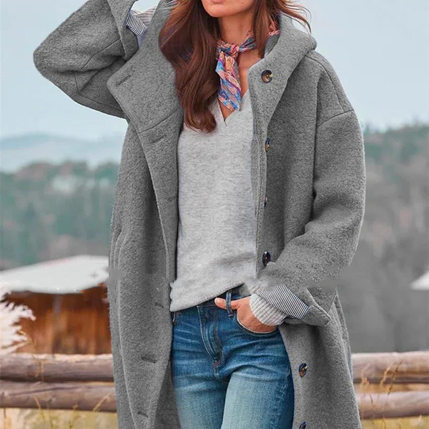 Women's oversized wool coat in bold blue with loose silhouette and statement button closure