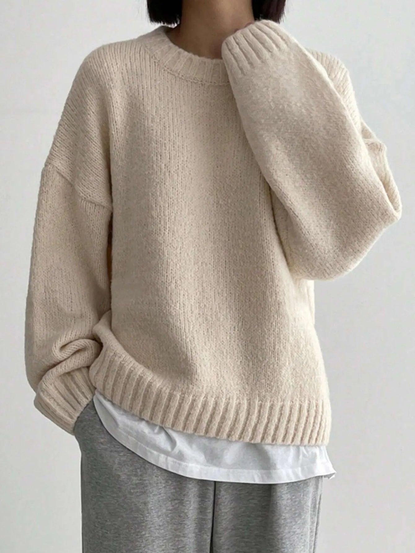 Pastel pink women's oversized knit sweater relaxed fit with ribbed neckline cuffs and hemline