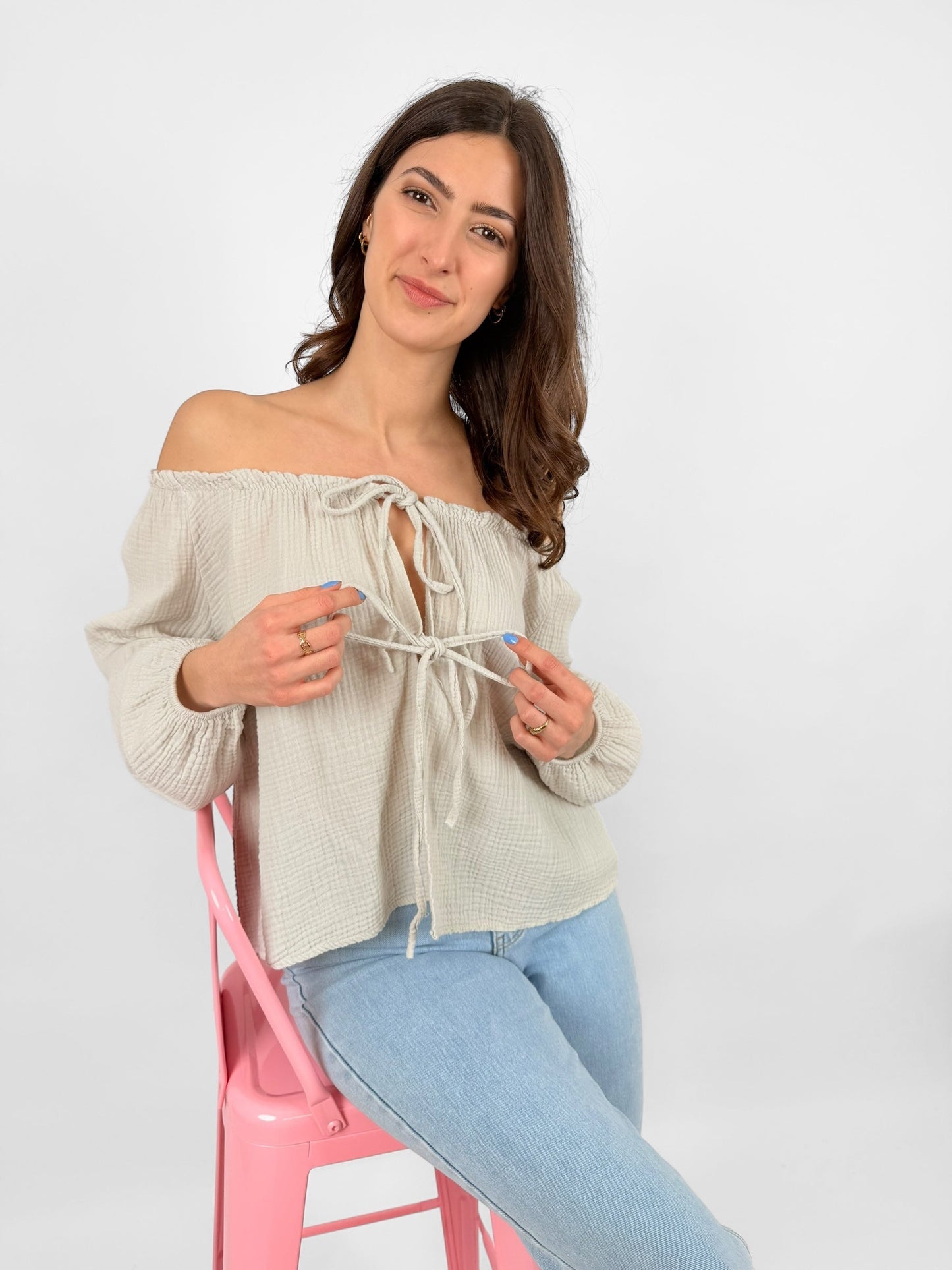 Women's white muslin blouse lightweight breathable fabric with delicate bow accents for everyday elegance