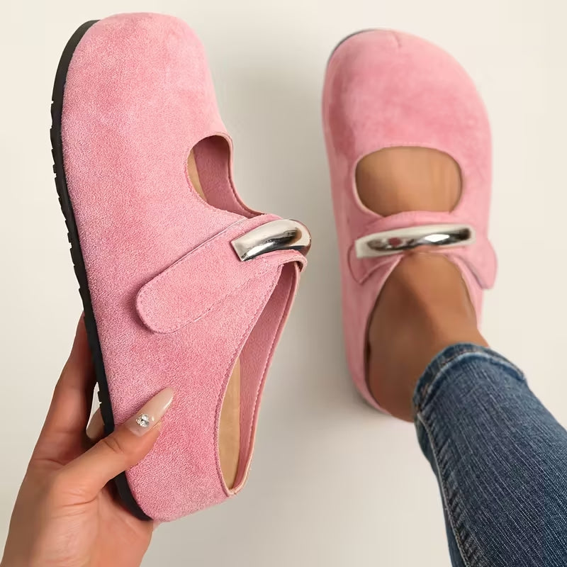Women's suede slip-on shoes with sculpted sole and bold metallic clasp accent for everyday wear