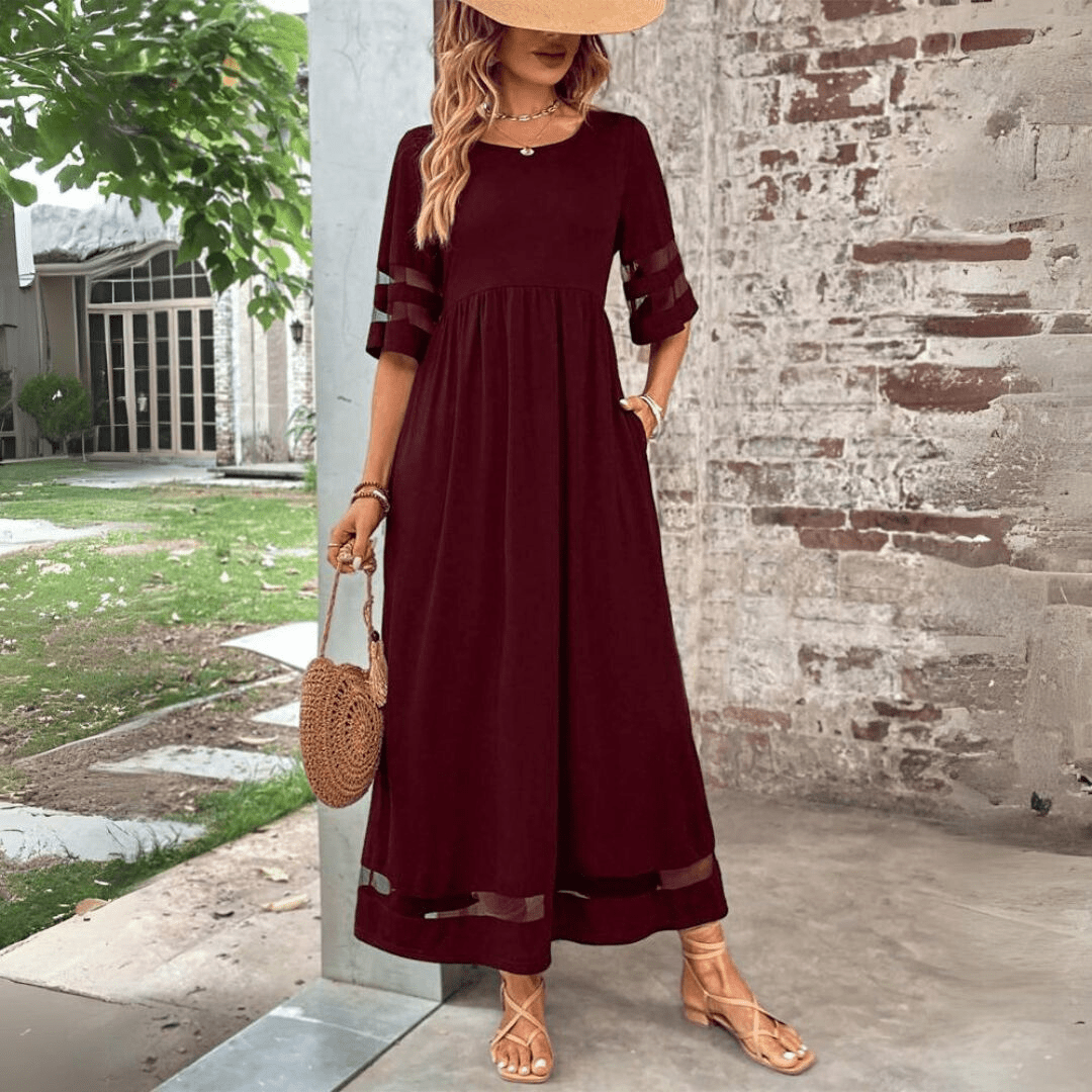 Black maxi dress with sheer sleeve panels, relaxed silhouette, raised waistline, round neckline
