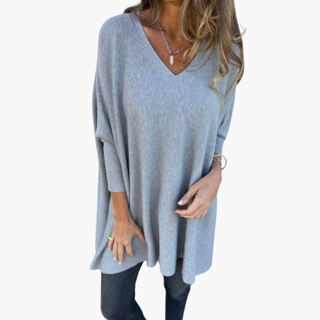 Women's loose-fit V-neck knit sweater in neutral tone, relaxed silhouette with elegant neckline