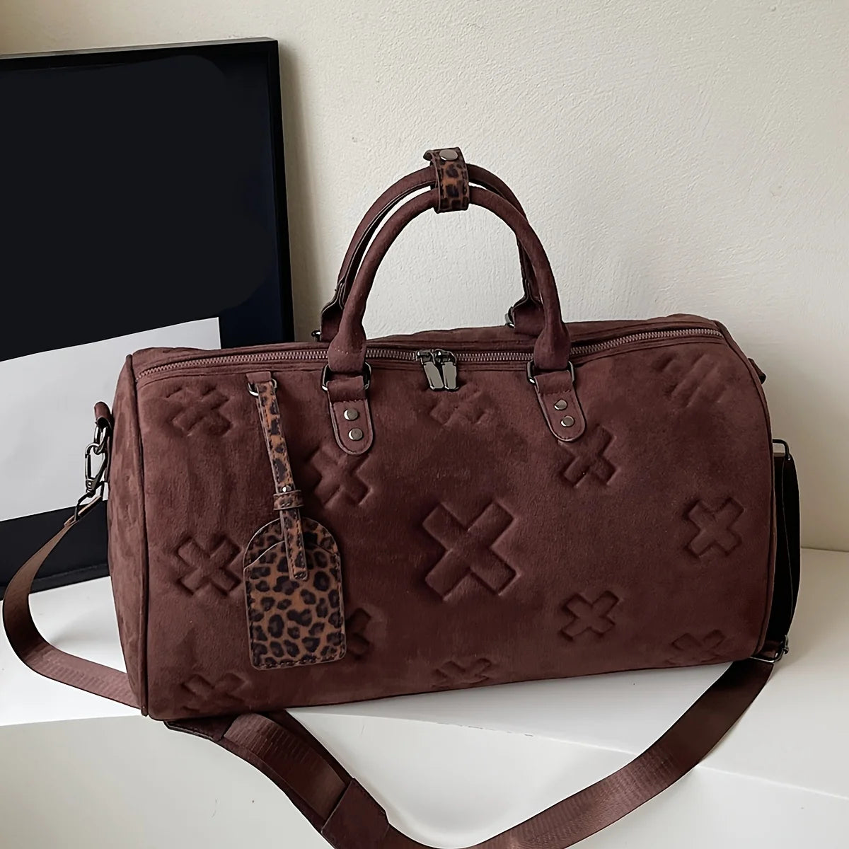 Axis suede weekender bag structured barrel silhouette embossed texture detachable strap unisex leather finish