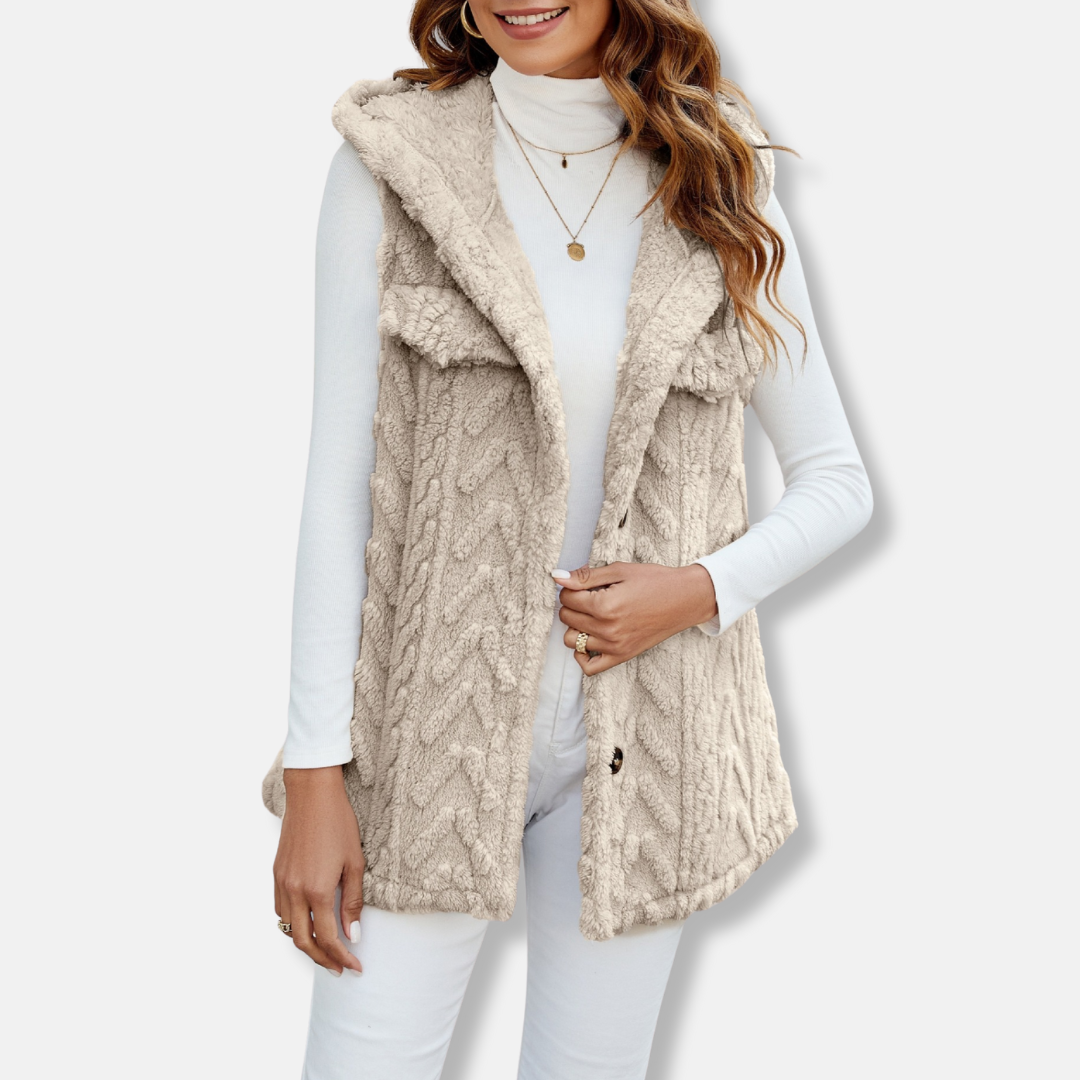 Women's beige cable knit hooded vest with plush fuzzy texture, relaxed fit, and side pockets