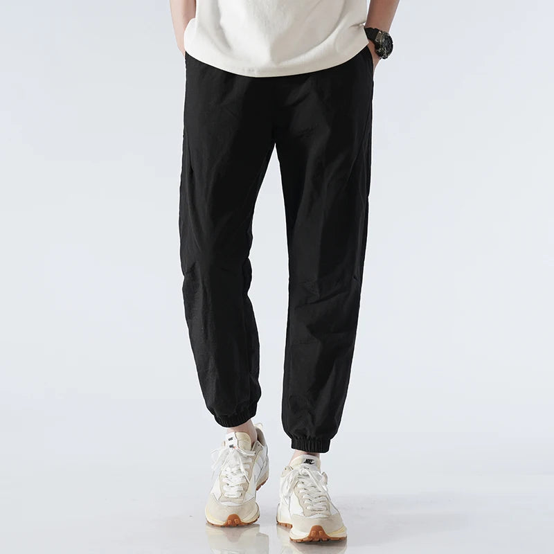 Men's gray tapered nylon jogger pants lightweight quick-dry activewear sleek modern silhouette