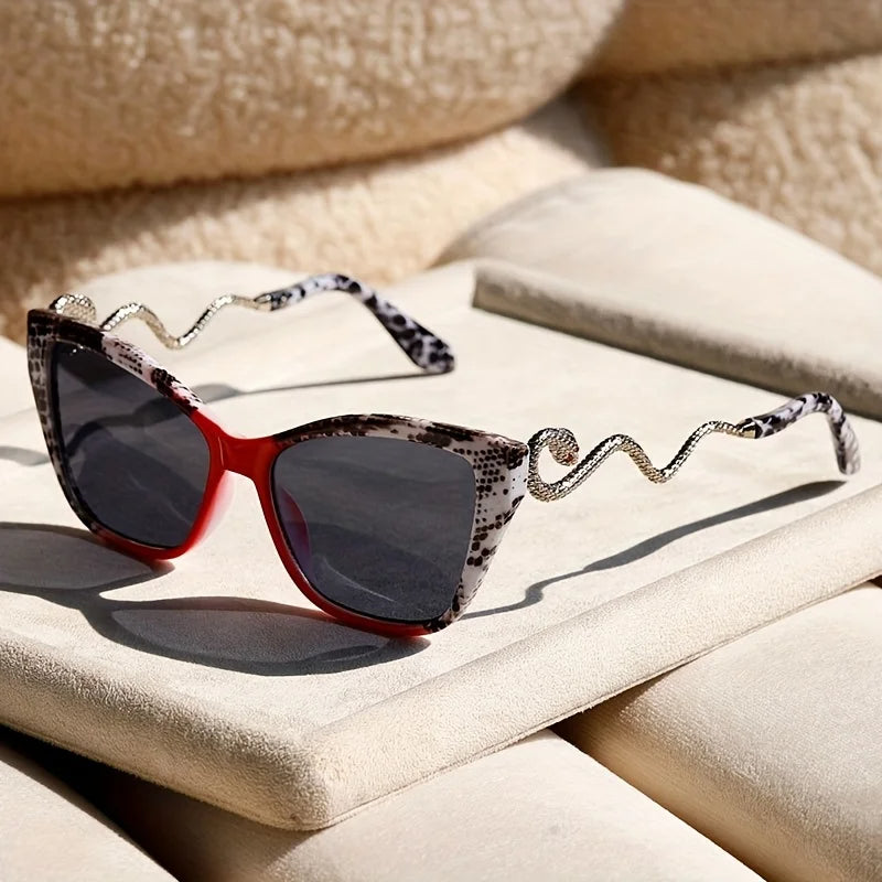 Oversized cat-eye sunglasses with sculpted snake arms, electric acetate finish, UV400 protection, bold fashion