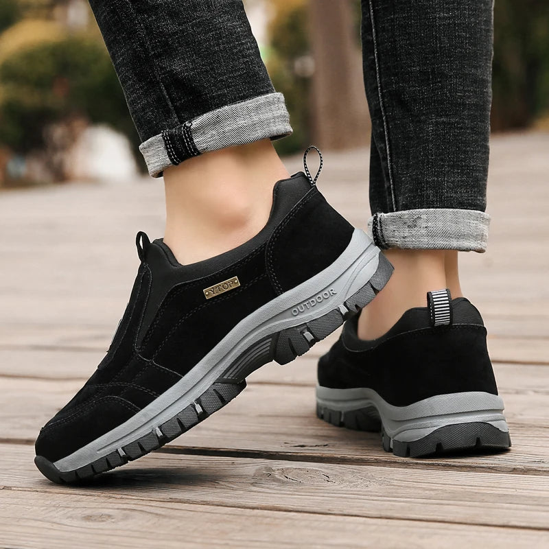 Men's gray slip-on outdoor sneakers with suede upper, elastic panels, and ultra-grip sole