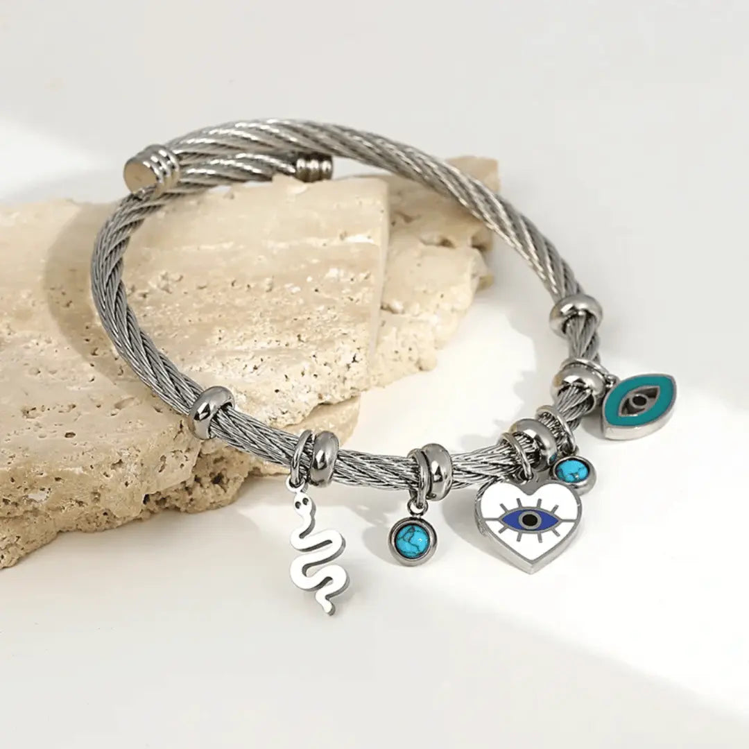 Handcrafted silver cuff bracelet with evil eye heart and snake charms for spiritual women