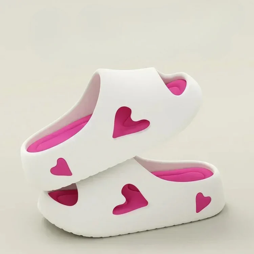 Women's ultra-light EVA foam slides with playful heart cutouts, cloudlike cushioning, casual everyday style