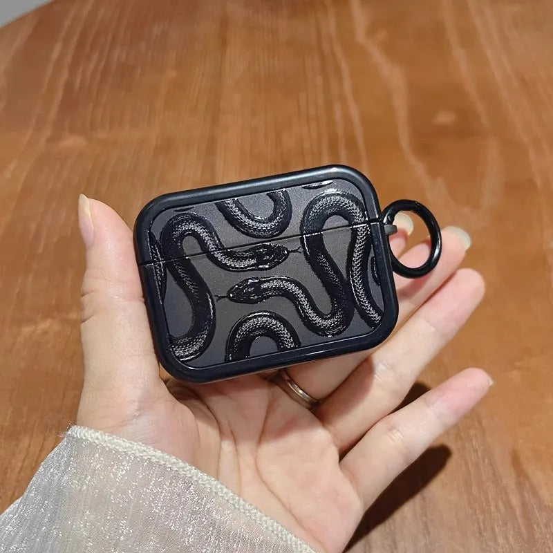 Matte black silicone AirPods case with serpent motif, shock-absorbent grip for active use