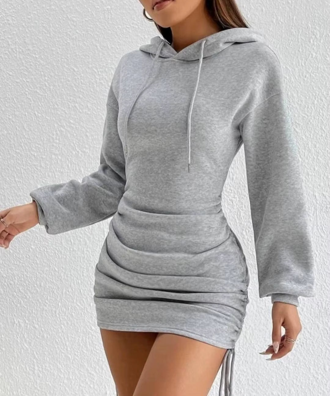 Women's black hoodie dress with adjustable side drawstrings, cozy chic figure-flattering silhouette