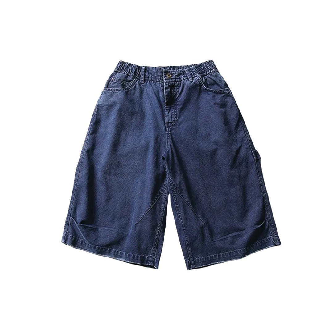 Men's oversized cotton canvas utility shorts in washed neutral tones with reinforced hem and cargo pockets