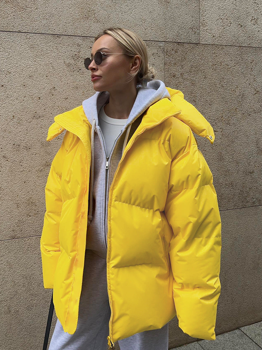 Women's oversized padded winter jacket with hood in neutral tone, cozy urban street style fit