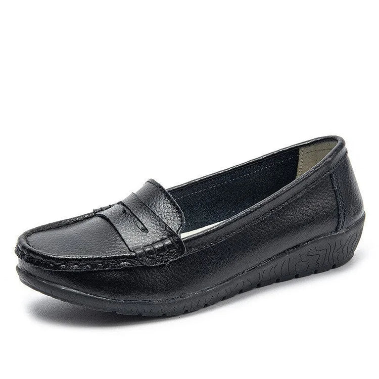 Women's black leather slip-on loafers with cushioned PU lining and flexible rubber sole for all-day comfort