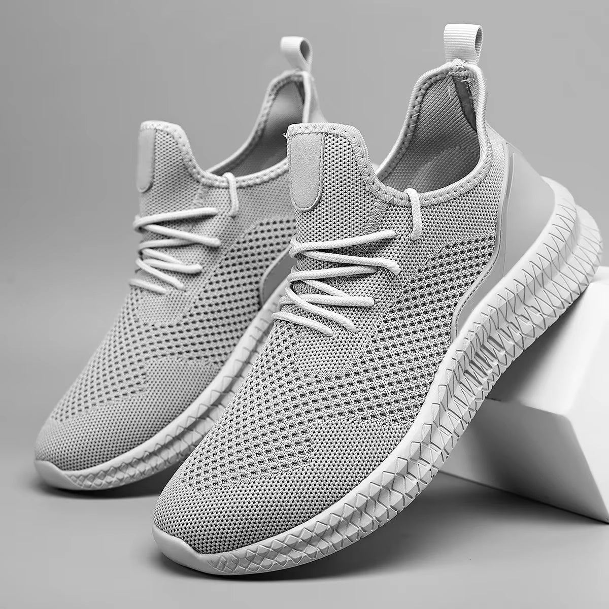 White lightweight athletic mesh sneaker with adaptive knit upper and all-day grip sole