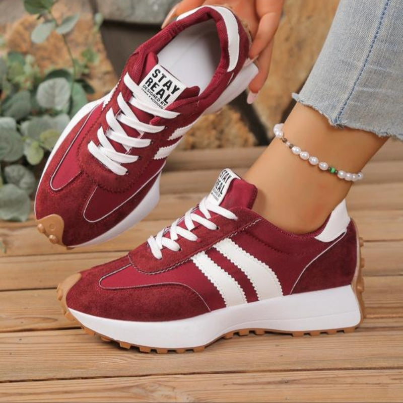 White women's platform lace-up sneakers with chic side stripe detail and trendy height-boosting sole