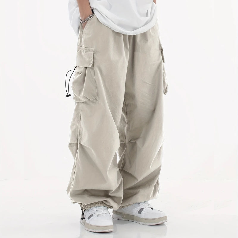 Men's wide-leg cargo pants neutral tone utility trousers with drawstring cuffs and multiple pockets