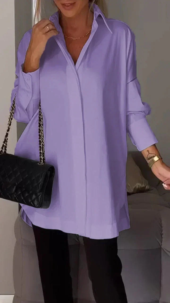 Women's oversized white blouse with rolled-up sleeves, relaxed silhouette, easy-care chic style