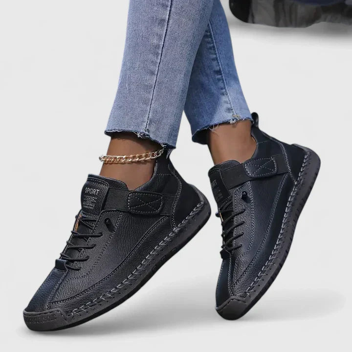 White high-top sneakers with stitched panels, lace-up front, adjustable strap, and structured urban silhouette