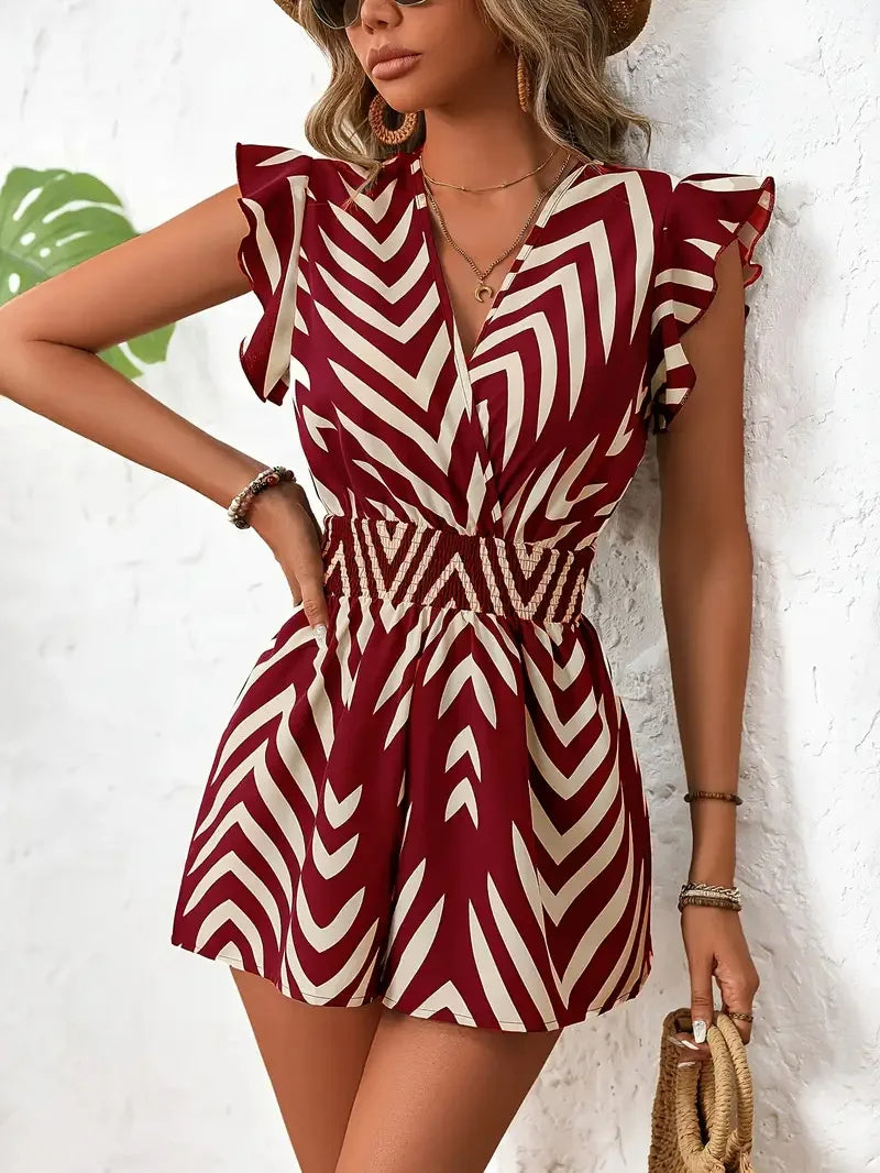 Women's chevron romper with smocked waist, deep V-neck, flutter sleeves, and sculpted fit