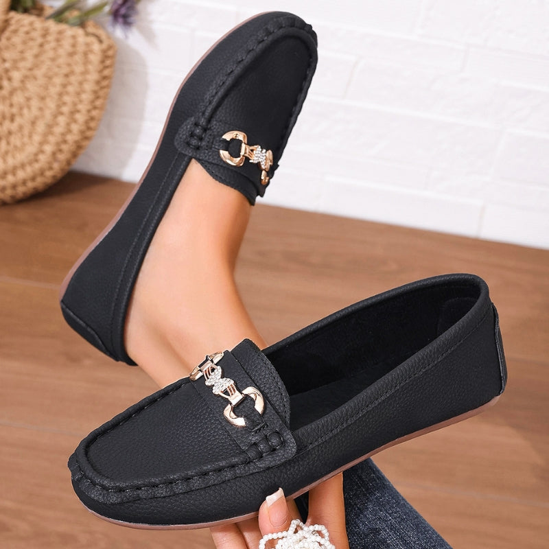 Women's slip-on loafers in neutral tone with round toe silhouette and subtle gold hardware accents