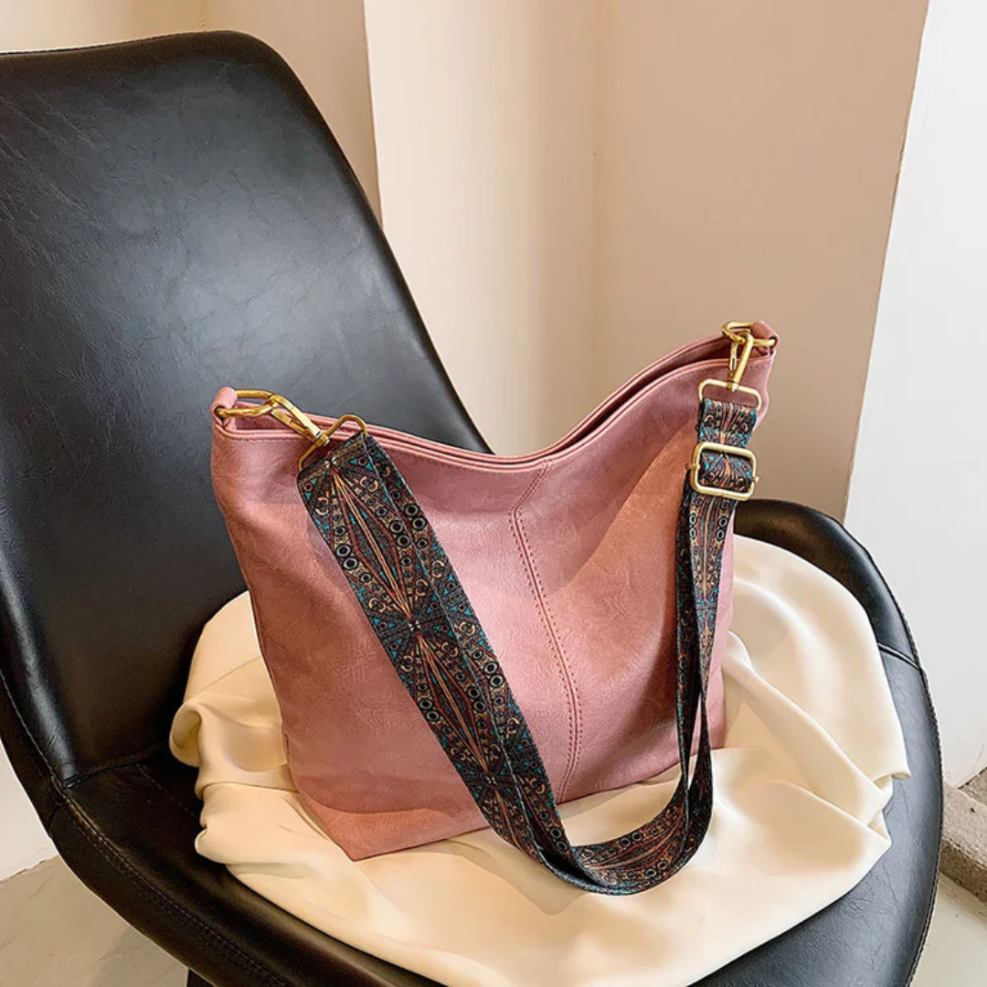 Women's shoulder bag with wide adjustable strap, large interior pocket, versatile everyday carry style