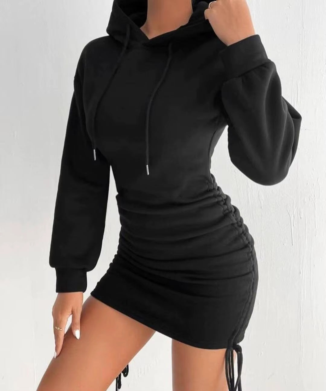 Women's black hoodie dress with adjustable side drawstrings, sleek figure-flattering cozy-chic silhouette