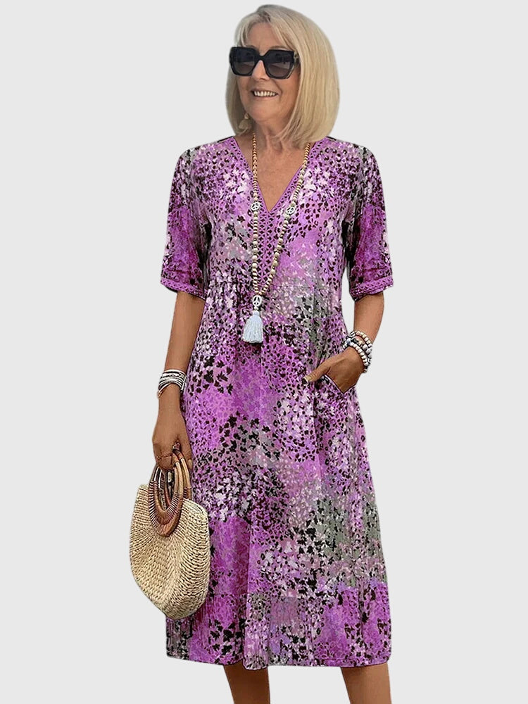 Women's printed midi dress with V-neckline, relaxed drape silhouette, and short sleeves for effortless everyday style