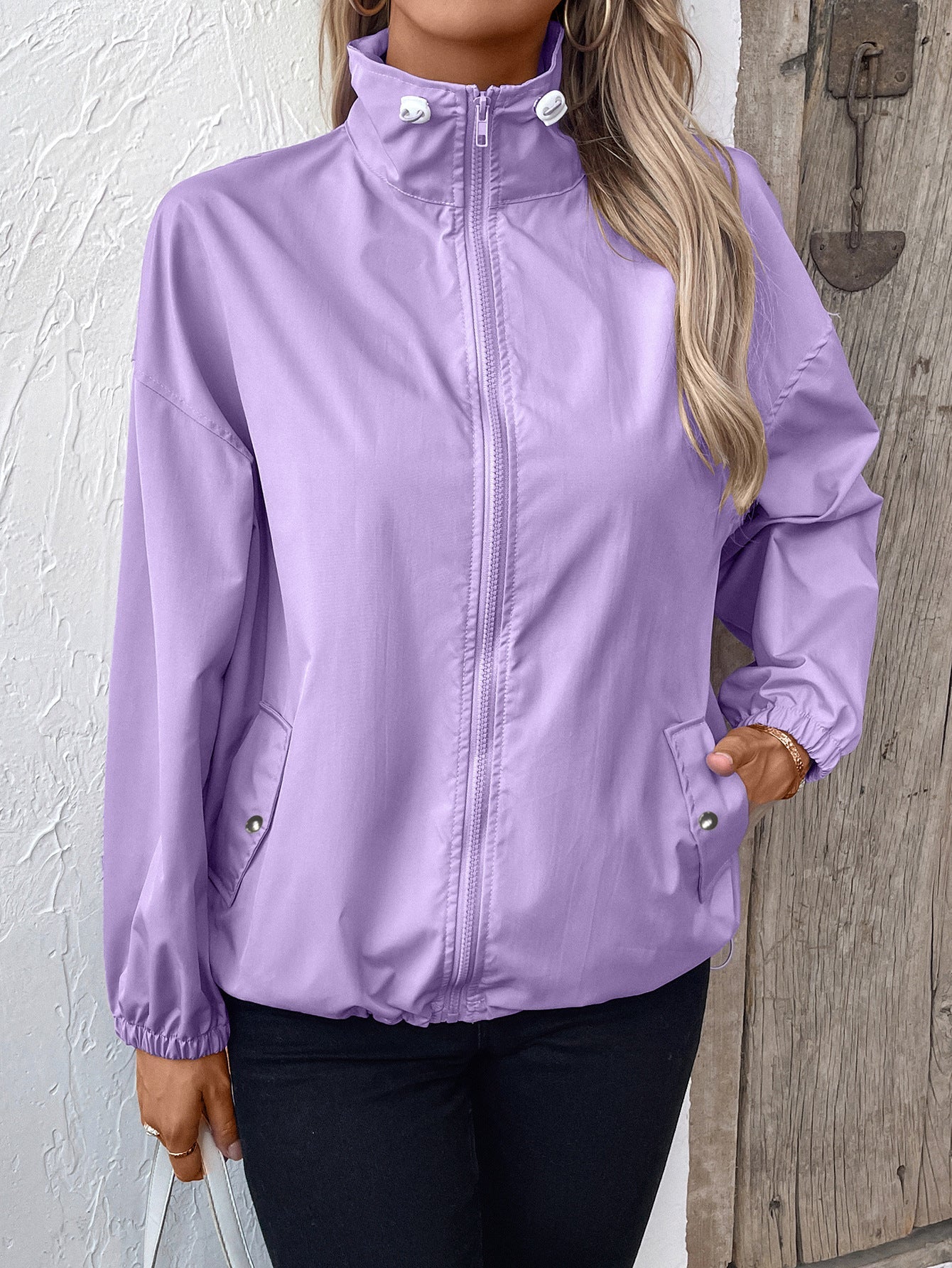 Women's lightweight waterproof raincoat, sleek outdoor athletic cut with storm-ready weather protection